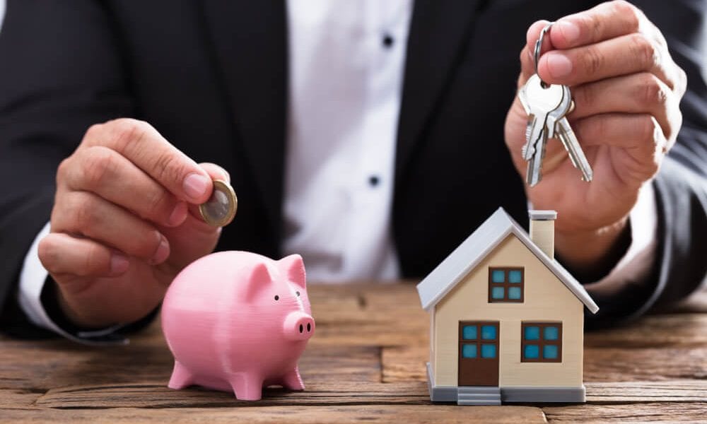 House with 401k piggy bank next to it